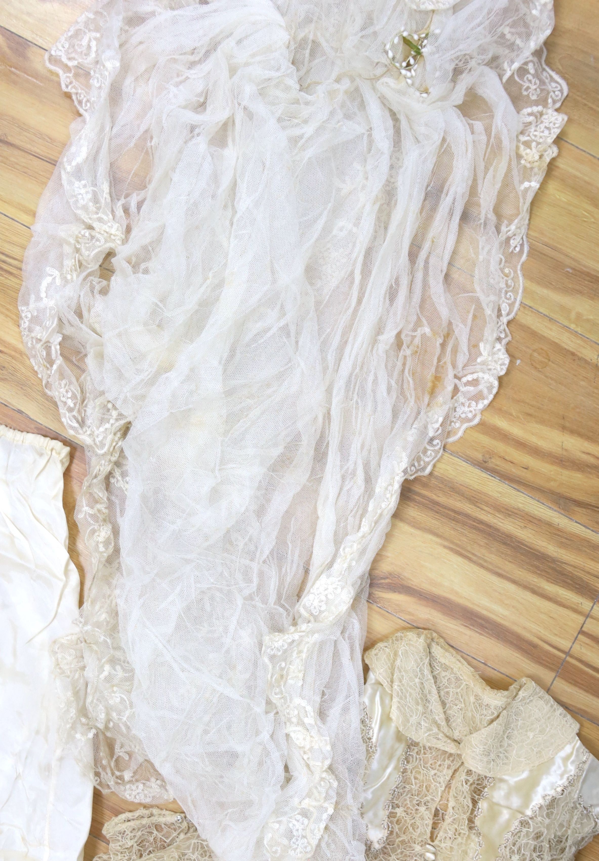 A 1930's lace and satin wedding dress including net veil